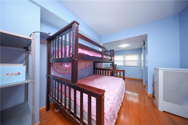 bedroom featuring baseboards and wood finished floors