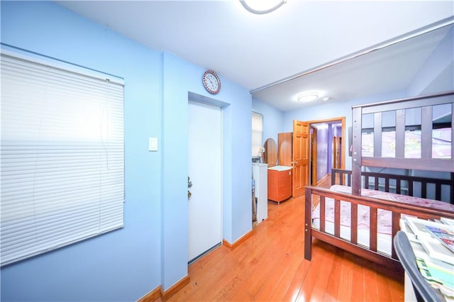 bedroom featuring baseboards and light wood-type flooring