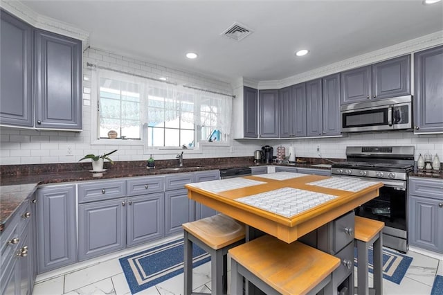 155-85 Bayview Ave, Rosedale, NY 11422 - kitchen featuring tasteful backsplash, visible vents, a sink, appliances with stainless steel finishes, and marble finish floor