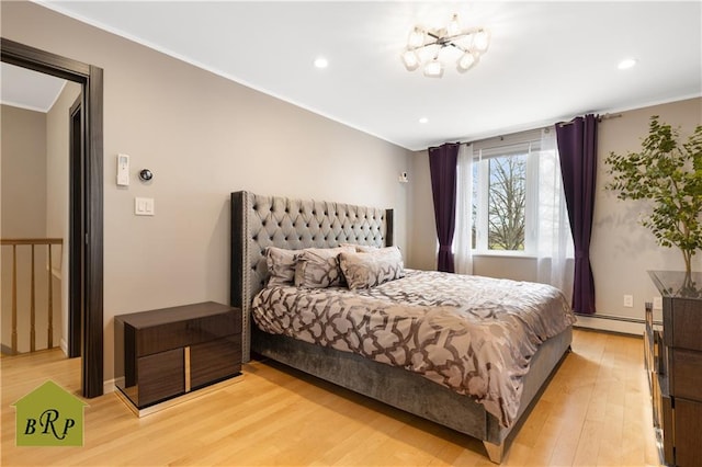 bedroom featuring light wood-style flooring, a chandelier, a baseboard heating unit, recessed lighting, and ornamental molding