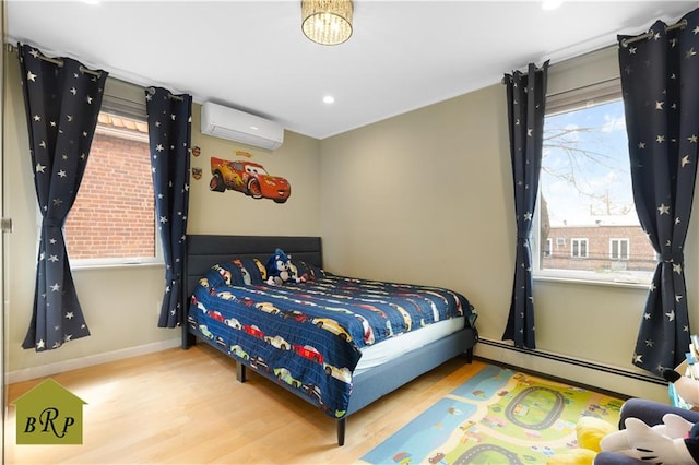 bedroom with recessed lighting, baseboards, an AC wall unit, wood finished floors, and a baseboard radiator