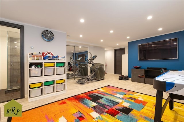 workout room featuring recessed lighting and wood finished floors