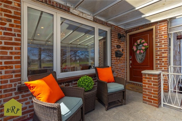 doorway to property featuring brick siding