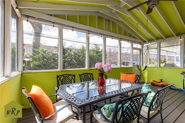 sunroom featuring ceiling fan and outdoor dining area