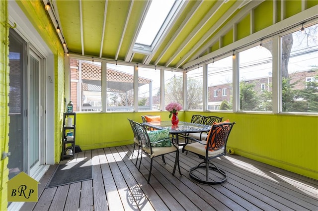 sunroom featuring outdoor dining area