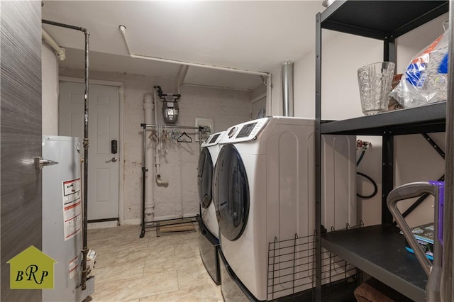 laundry area featuring gas water heater, washing machine and dryer, and laundry area