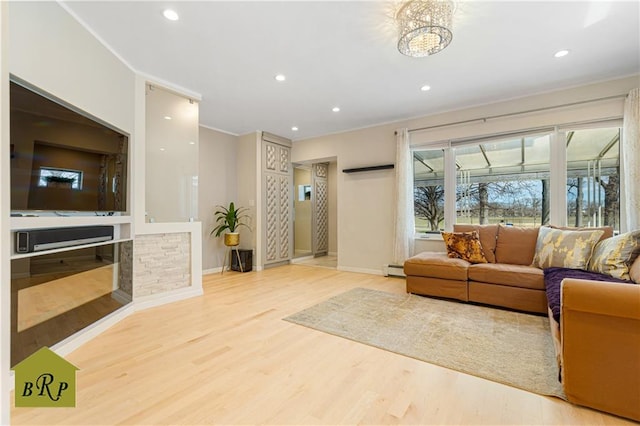living area with ornamental molding, recessed lighting, and wood finished floors