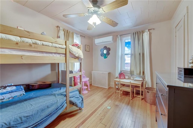 447 Greeley Ave, Staten Island, NY 10306 - bedroom featuring radiator, a wall mounted AC, light wood-style floors, and a ceiling fan