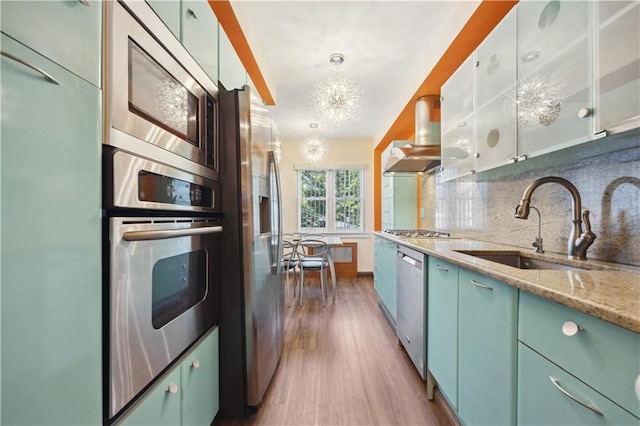 4640 Bedford Ave, Brooklyn, NY 11235 - kitchen featuring tasteful backsplash, a sink, appliances with stainless steel finishes, wood finished floors, and island range hood