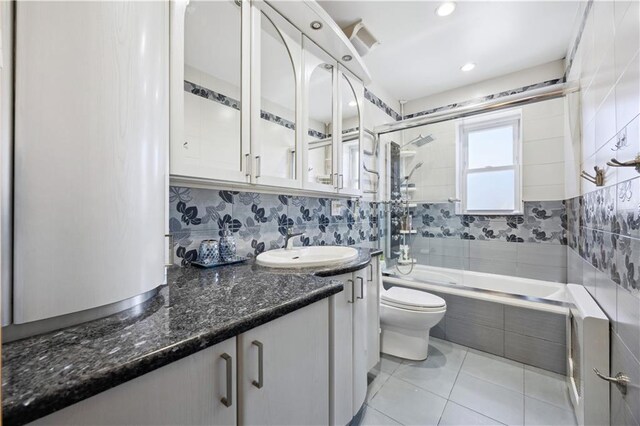 4640 Bedford Ave, Brooklyn, NY 11235 - full bathroom with visible vents, toilet, vanity, tile patterned flooring, and tiled shower / bath