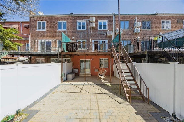 4640 Bedford Ave, Brooklyn, NY 11235 - rear view of property with a patio area, brick siding, fence, stairs, and a deck