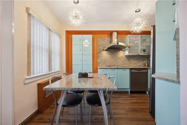 4640 Bedford Ave, Brooklyn, NY 11235 - kitchen with an inviting chandelier, wall chimney range hood, dark wood-style floors, decorative backsplash, and appliances with stainless steel finishes