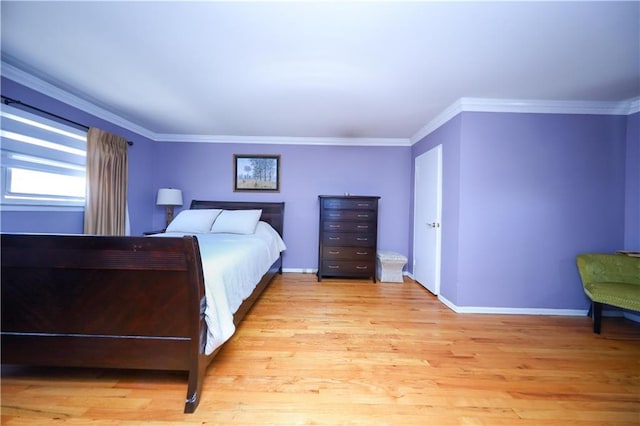 bedroom featuring light wood-type flooring, baseboards, and crown molding