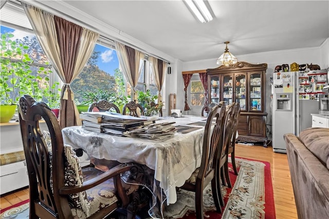 1655 Flatbush Ave Unit B204, Brooklyn, NY 11210 - dining space featuring a healthy amount of sunlight, ornamental molding, and light wood finished floors
