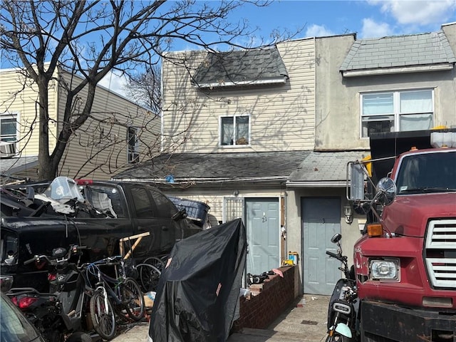 21 Preston Ct, Brooklyn, NY 11234 - view of front of home featuring stucco siding and roof with shingles