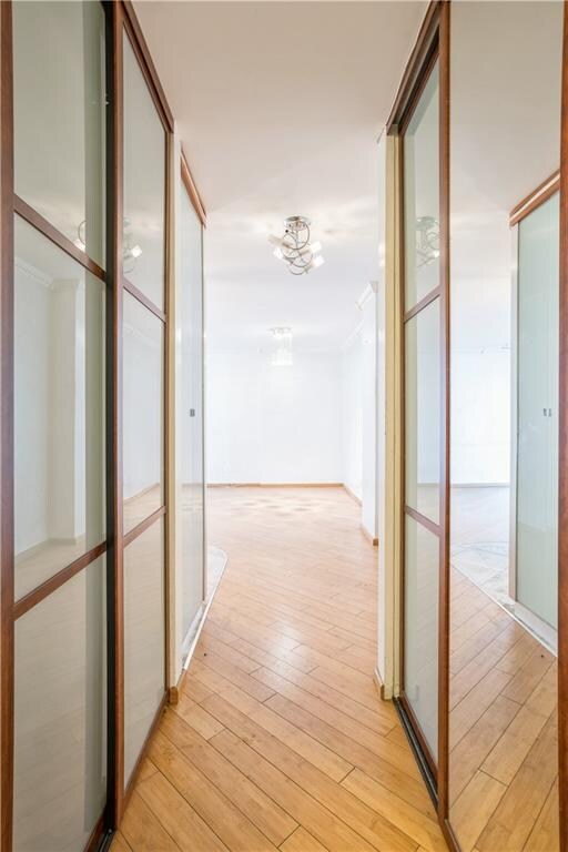2944 W 5th St Unit 14F, Brooklyn, NY 11224 - corridor featuring light wood finished floors and a chandelier