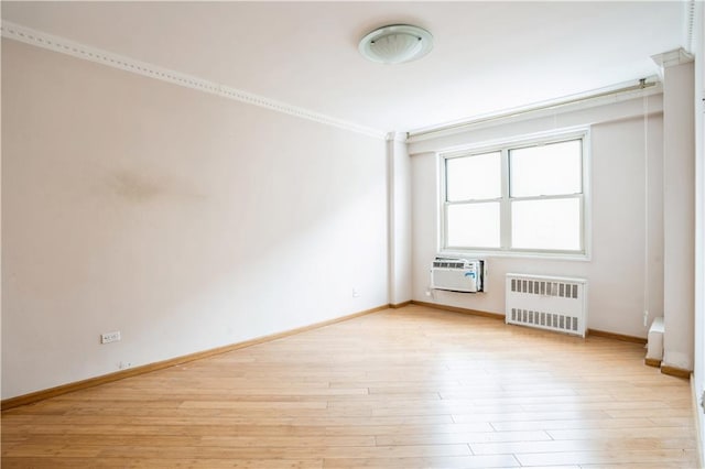 2944 W 5th St Unit 14F, Brooklyn, NY 11224 - unfurnished room with radiator, baseboards, light wood-style flooring, a wall mounted AC, and ornamental molding
