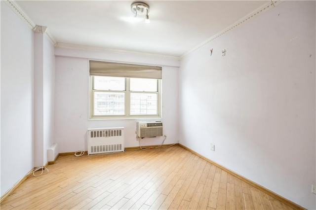 2944 W 5th St Unit 14F, Brooklyn, NY 11224 - spare room with radiator heating unit, ornamental molding, light wood finished floors, and baseboards