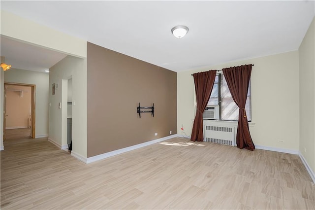 2645 Homecrest Ave Unit 4C, Brooklyn, NY 11235 - spare room featuring radiator, light wood finished floors, baseboards, and cooling unit
