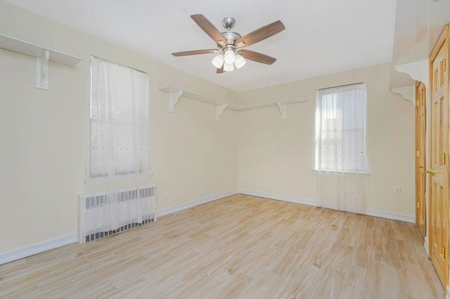 2645 Homecrest Ave Unit 4C, Brooklyn, NY 11235 - unfurnished room featuring radiator heating unit, ceiling fan, wood finished floors, and baseboards