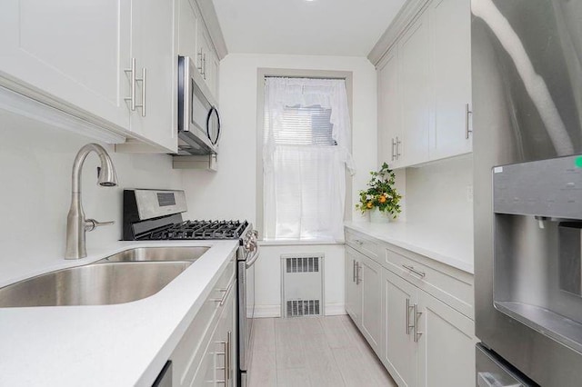 2645 Homecrest Ave Unit 4C, Brooklyn, NY 11235 - kitchen featuring stainless steel appliances, a sink, light countertops, and radiator heating unit
