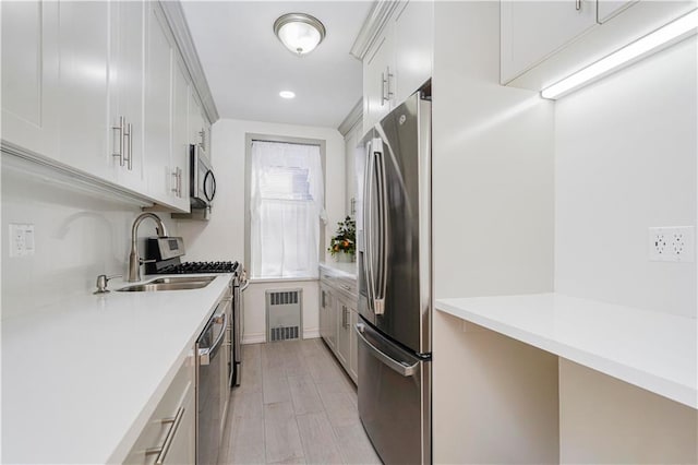 2645 Homecrest Ave Unit 4C, Brooklyn, NY 11235 - kitchen with stainless steel appliances, a sink, light countertops, white cabinetry, and light wood finished floors