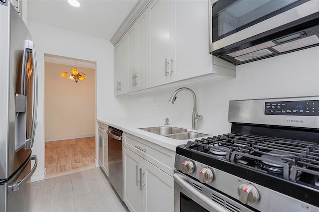 2645 Homecrest Ave Unit 4C, Brooklyn, NY 11235 - kitchen featuring stainless steel appliances, a sink, light countertops, white cabinetry, and light wood-type flooring