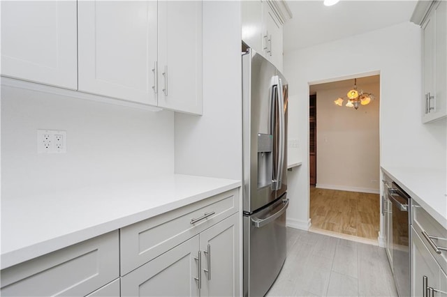 2645 Homecrest Ave Unit 4C, Brooklyn, NY 11235 - kitchen featuring appliances with stainless steel finishes, light countertops, white cabinetry, baseboards, and recessed lighting