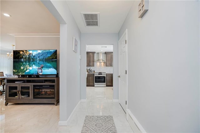 hall featuring ornamental molding, visible vents, a chandelier, marble finish floor, and baseboards