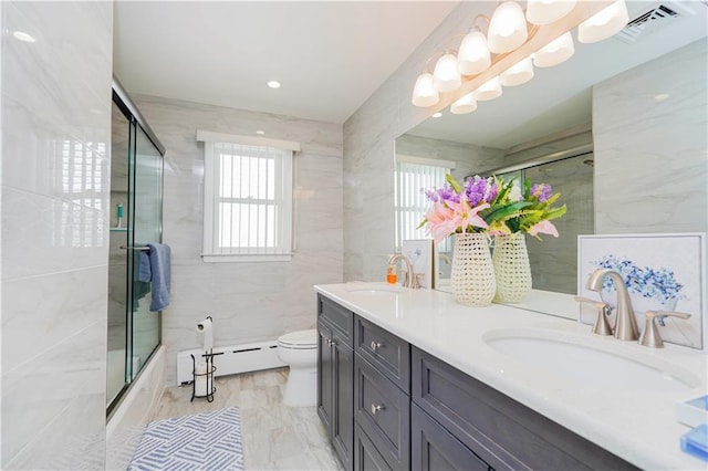 bathroom featuring a sink, visible vents, marble finish floor, and baseboard heating
