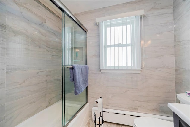 full bath featuring enclosed tub / shower combo, vanity, tile walls, and toilet