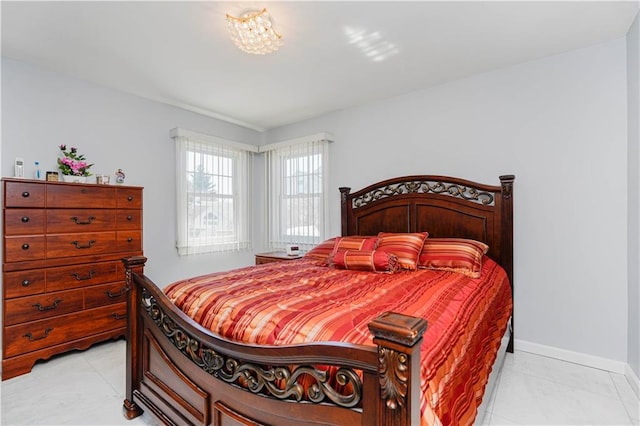 bedroom featuring light tile patterned floors and baseboards