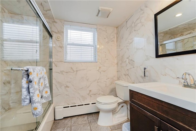 bathroom featuring baseboard heating, toilet, vanity, and tile walls