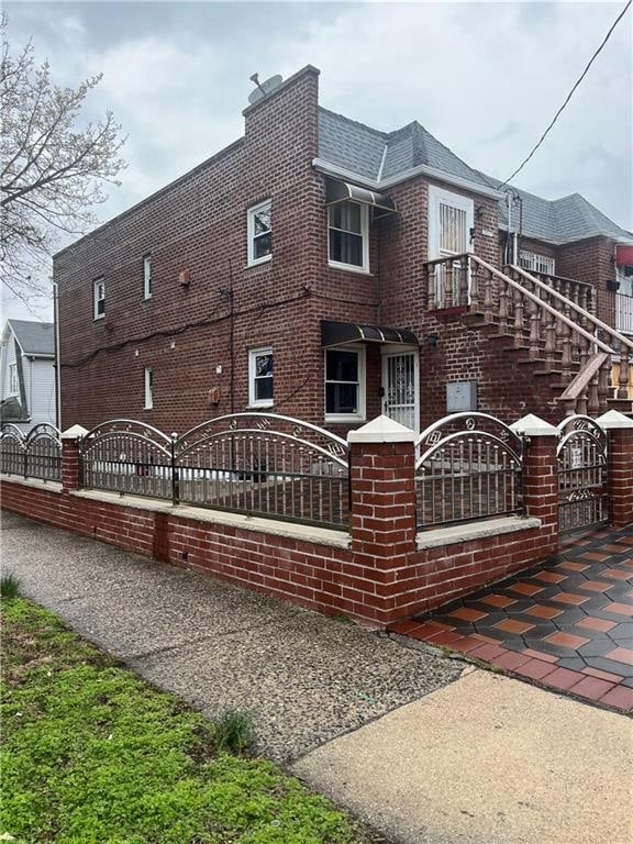 9801 Seaview Ave, Brooklyn, NY 11236 - view of home's exterior with a fenced front yard, brick siding, and a gate