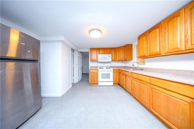 3029 Brighton 5th St Unit 3, Brooklyn, NY 11235 - kitchen featuring white appliances, light countertops, and brown cabinets