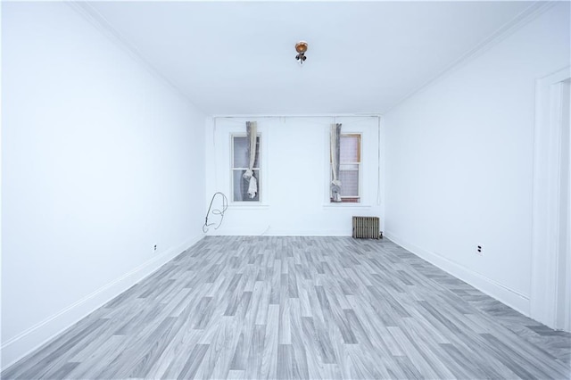 3029 Brighton 5th St Unit 3, Brooklyn, NY 11235 - unfurnished room with radiator heating unit, wood finished floors, and ornamental molding
