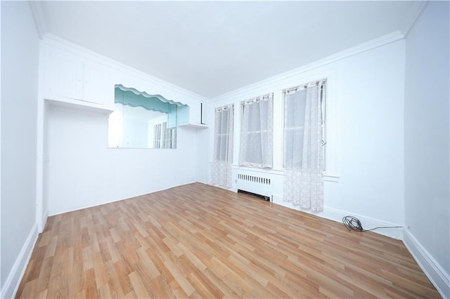 3029 Brighton 5th St Unit 3, Brooklyn, NY 11235 - unfurnished room with radiator, light wood-style floors, and crown molding