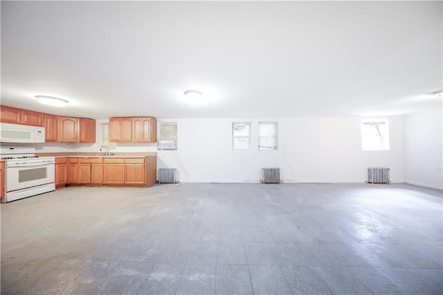 3029 Brighton 5th St Unit 3, Brooklyn, NY 11235 - kitchen with white appliances, radiator heating unit, and open floor plan