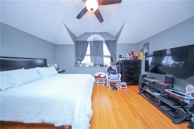 bedroom with wood finished floors, a ceiling fan, and lofted ceiling