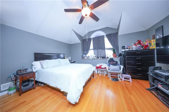bedroom featuring visible vents, ceiling fan, wood finished floors, and lofted ceiling