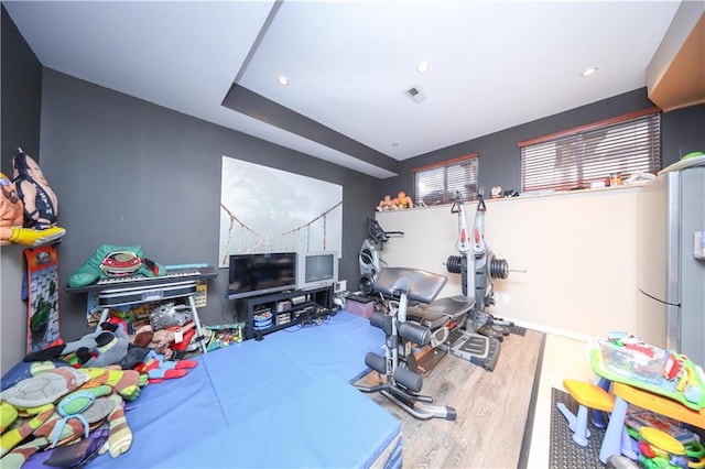 playroom featuring wood finished floors, recessed lighting, and visible vents