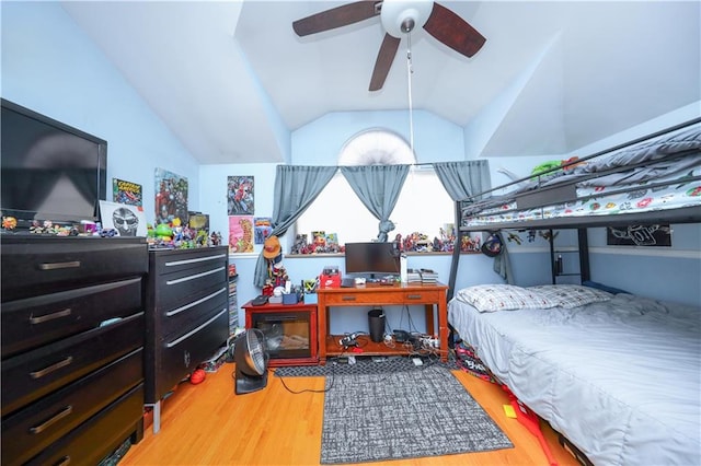 bedroom with wood finished floors and vaulted ceiling