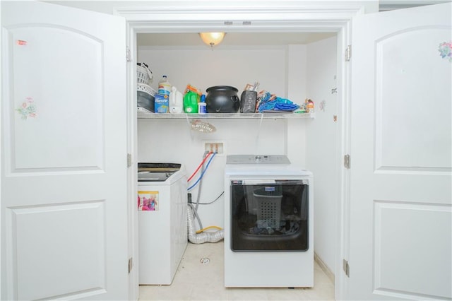 clothes washing area featuring independent washer and dryer and laundry area