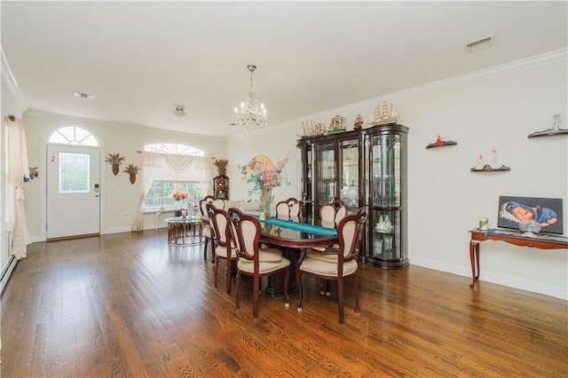 dining area with wood finished floors, an inviting chandelier, ornamental molding, and visible vents
