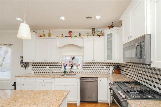 kitchen with a sink, white cabinetry, and stainless steel appliances