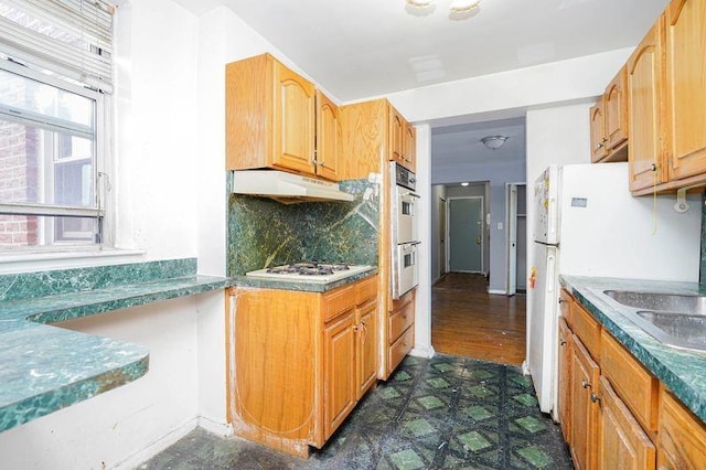 1580 E 13th St Unit 5C, Brooklyn, NY 11230 - kitchen featuring dark floors, under cabinet range hood, white gas cooktop, decorative backsplash, and double oven
