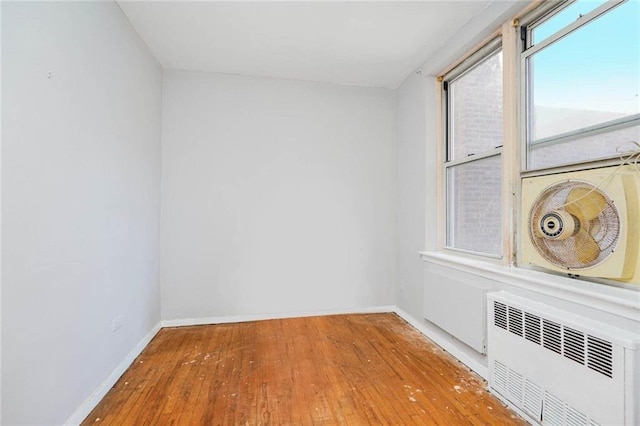 1580 E 13th St Unit 5C, Brooklyn, NY 11230 - unfurnished room with radiator heating unit, wood-type flooring, and baseboards