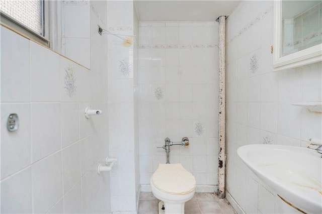 bathroom featuring tile walls, toilet, and tile patterned flooring
