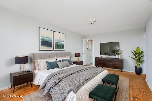 bedroom featuring wood finished floors and baseboards