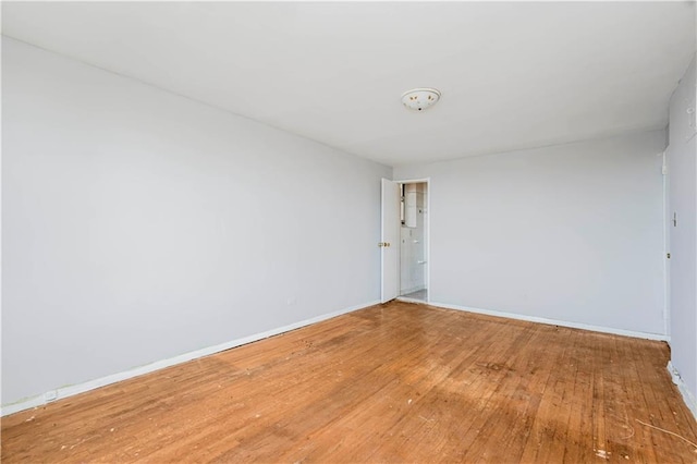 unfurnished room featuring wood finished floors and baseboards